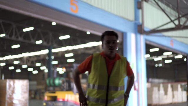 Senior Asian custom officer opening an industrial container door to inspect the item inside container.
