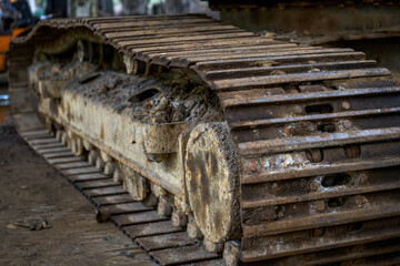 Close-up of an abandoned old excavator crawler