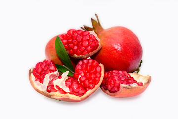 Fresh ripe pomegranate with green leaves isolated on white background