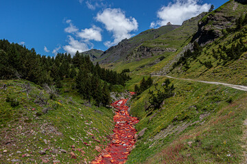 red river between mountains of the Pyrenees
