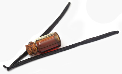 Vanilla pods with essence in a bottle