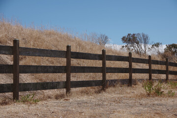 Dark wooden fence in a rural drought stricken landscape area