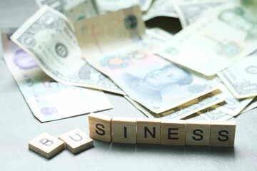 Letters, words, business, background, dollar and yuan, business concepts that affect the global economy and investment. The business was damaged by profits.