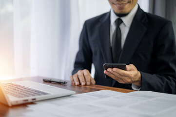 Businessman using smartphone mobile technology in office