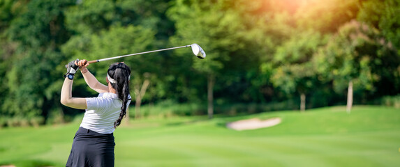 Professional woman golfer teeing golf in golf tournament competition at golf course for winner.	