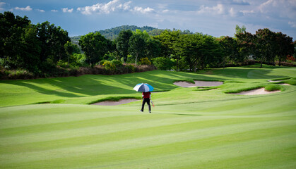 Professional golfer teeing golf in golf tournament competition at golf course for winner	