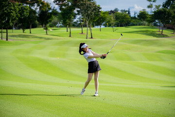 Professional woman golfer teeing golf in golf tournament competition at golf course for winner.	
