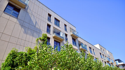 Exterior of new apartment buildings on a blue cloudy sky background. No people. Real estate business concept.