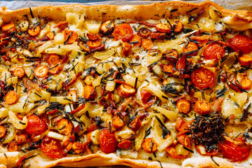 Pita, open pastry pie baked on baking sheet in oven, stuffed with vegetables and herbs