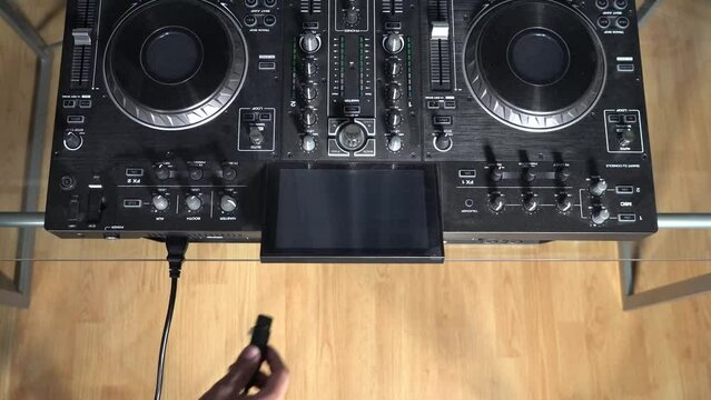 Connecting power and XLR cables to DJ mixer (Aerial)