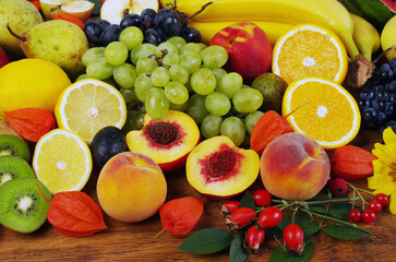 A variety of fresh ripe fruits on a wooden table.