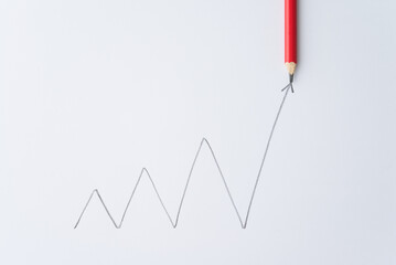Pencil write chart graph swing growing with arrow trend rise up on white paper background. Career...