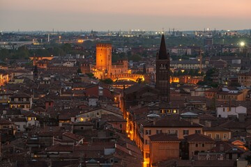 Verona, Italy town skyline on the Adige River at dusk.
