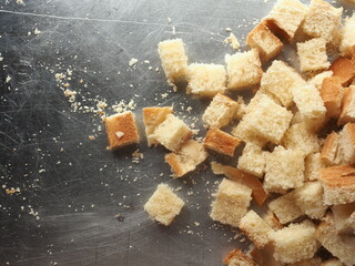 Top view white bread cubes on stainless steel working surface