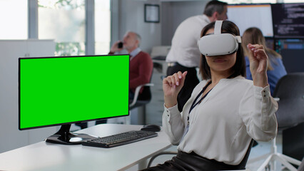 Naklejka na ściany i meble Office employee work in augmented reality headset sitting at workplace