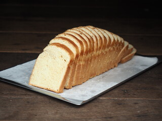 sliced white bread loaf on baking tray