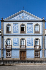 Fototapeta na wymiar Aveiro, beautiful city in Portugal, old blue house with azulejos, on the canal, in the historical center 