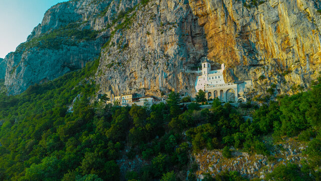 Evening view of Ostrog orthodox monastery in Montenegro or Crna gora, popular pilgrimage point in the balkans, viewed from drone perspective in sunny evening.