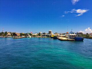 Fototapeta na wymiar Harbor port of Isla Mujeres Island with buildings and boats