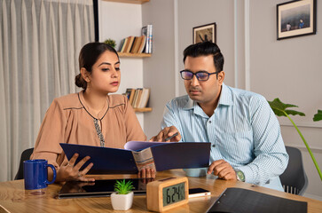 Indoor shot of an Asian Indian male and female or mixed Gender formal corporate employees or...