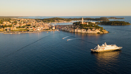 Beautiful Rovinj town (popular tourist resort and an active fishing port) at sunset. Aerial photo. The old town of Rovinj, Istria, Croatia.