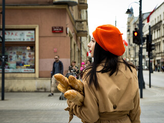 A girl in a coat and beret in the French style - obrazy, fototapety, plakaty