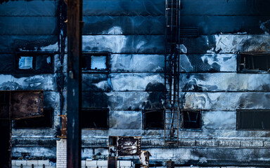 Bucha region, Ukraine - May 22, 2022: the facade of a burned-out enterprise, as a result of the direct impact of Russian missiles on civilian objects