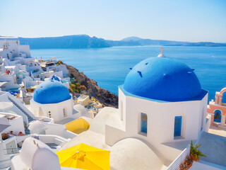Santorini, Greece. Small narrow streets and rooftops of houses, churches and hotels. Oia village,...