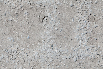 Seamless texture of rough gray concrete with stones