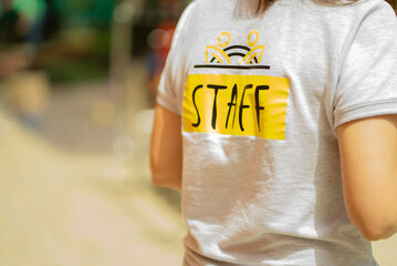 Fototapeta na wymiar Staff t-shirt written with yellow letters