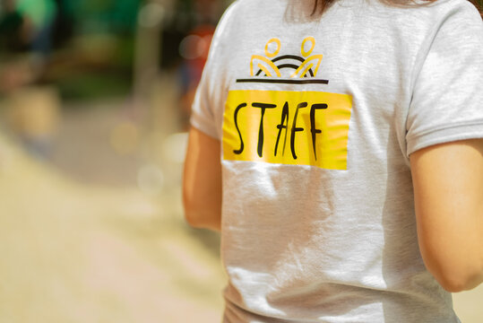 Staff t-shirt written with yellow letters