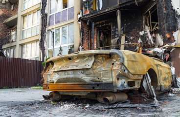 Atrocities of the russian army in the suburbs of Kyiv. Automobile and houses in of civilians...
