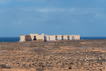 Foto panorámica de un edificio en ruinas en medio de un paisaje volcánico y desértico durante un caluroso día de verano en Lanzarote, islas Canarias.