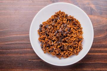Jajangmyeon or JJajangmyeon instant noodles black bean sauce Korean food style in a white cup.