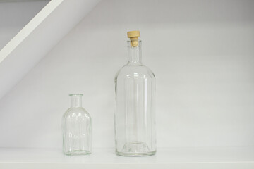 White empty glass decorative bottles in the interior