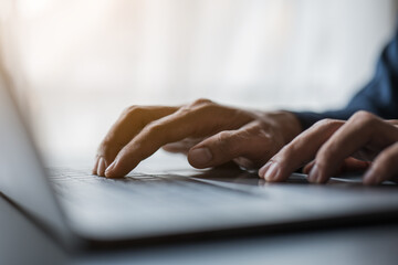 Close up of hands and fingers typing the keyboard.