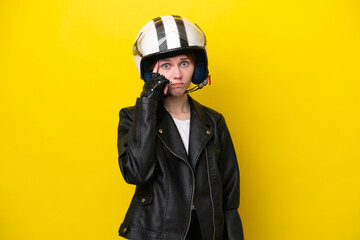 Young English woman with a motorcycle helmet isolated on yellow background thinking an idea