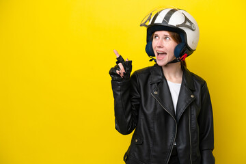 Young English woman with a motorcycle helmet isolated on yellow background intending to realizes the solution while lifting a finger up