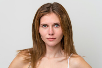 Naklejka premium Portrait of pretty young woman over isolated white background