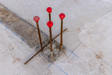 Pillar rebars with plastic caps. Construction site with steel reinforcing bars for concrete...