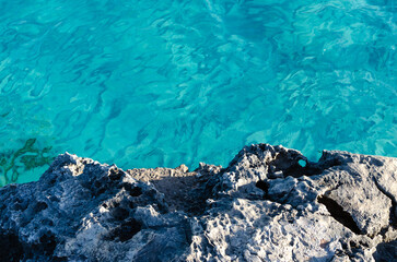 rock textures and turquoise sea