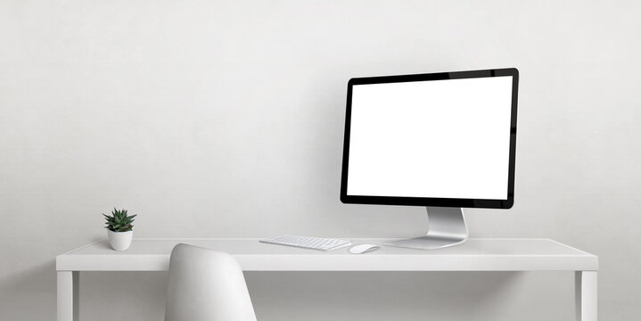 Computer display mockup on work desk with copy space beside on white wall. Isolated display screen for web page promotion