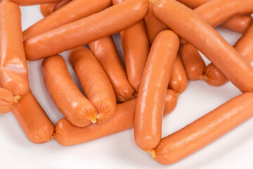 Small thin sausages on dish close-up in selective focus