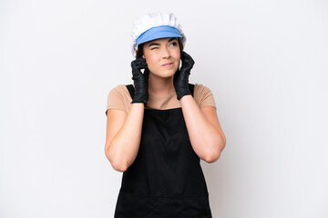 Fishmonger brazilian woman wearing an apron isolated on white background frustrated and covering ears
