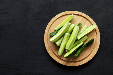 Slices of fresh cucumbers on a cutting board.