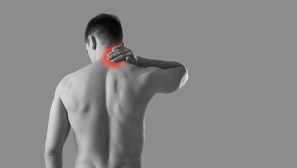 Neck pain. Rear view of man rubbing his sore neck while standing on gray banner background. Black...