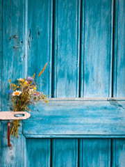 Flower bouqet on old farm house door