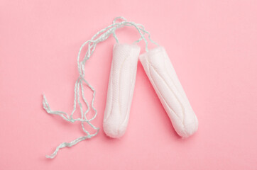Tampons on pink background top view