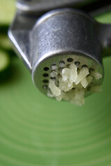 grated squeezed garlic with green cucumber. close-up. macro.