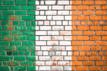National  flag of the Ireland  on a grunge brick background.